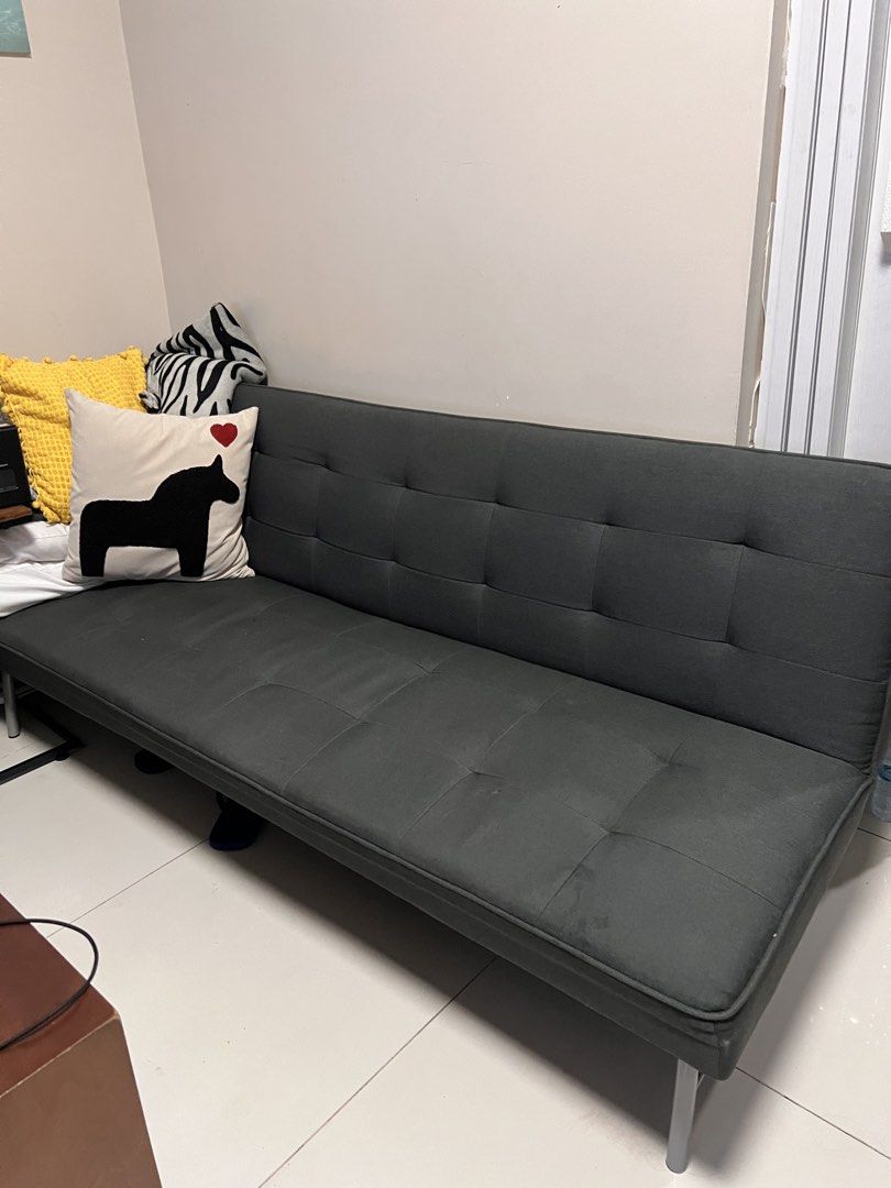 Dark Grey Tufted Sofa Bed (Category: Sofas) located in Manila. Submitted by kai.168 (Listing ID 1468714369, Image 1). Description: - Color: Dark grey with elegant tufted button detailing - Function: Easily folds down flat to convert into a bed - Frame & Support: Solid metal support structure with sleek metal legs - Versatility: Neutral color fits most living rooms or guest rooms - Note: Accent pillows shown in photos are not included.