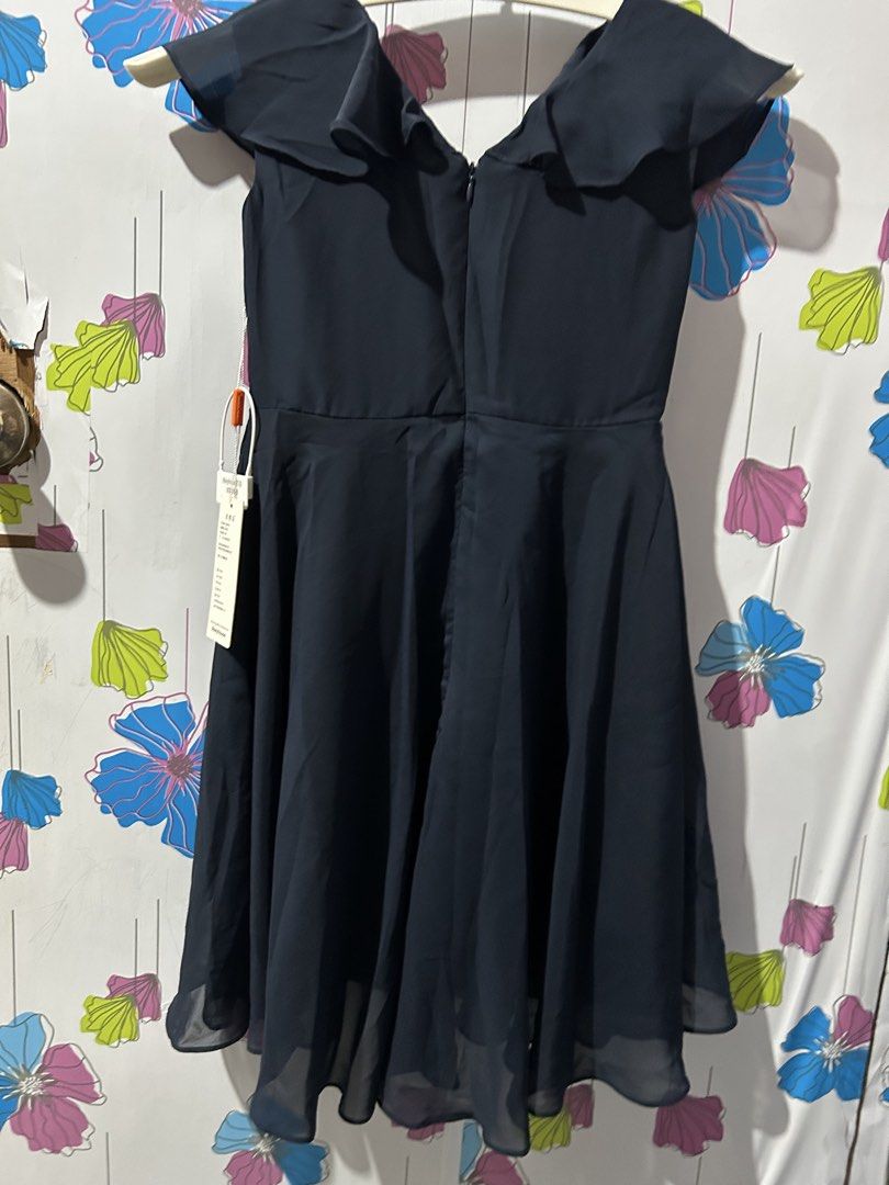Dark Navy Blue Ruffle V-Neck Dress (Category: Babies & Kids Fashion) located in San Jose. Submitted by coolbear-85a9de (Listing ID 1468714549, Image 3). Description: - Color: Dark navy blue - Style: Ruffled V-neck, short flutter sleeves, flared midi-length skirt - Condition: Brand new with original tags attached, clean and ready to wear - Details: Lightweight chiffon-like fabric, fully lined, back zipper closure - Versatility: Simple and classic,