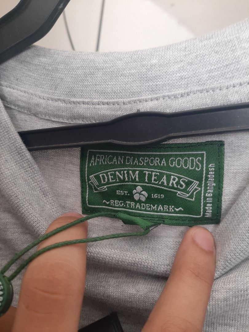 Denim tears (Category: Formal Shirts) located in Caloocan City. Submitted by oddriver_c0926d (Listing ID 1468751493, Image 2). Description: Heather grey oversized cotton fabric, complete with its original green brand tag attached near the crewneck collar.