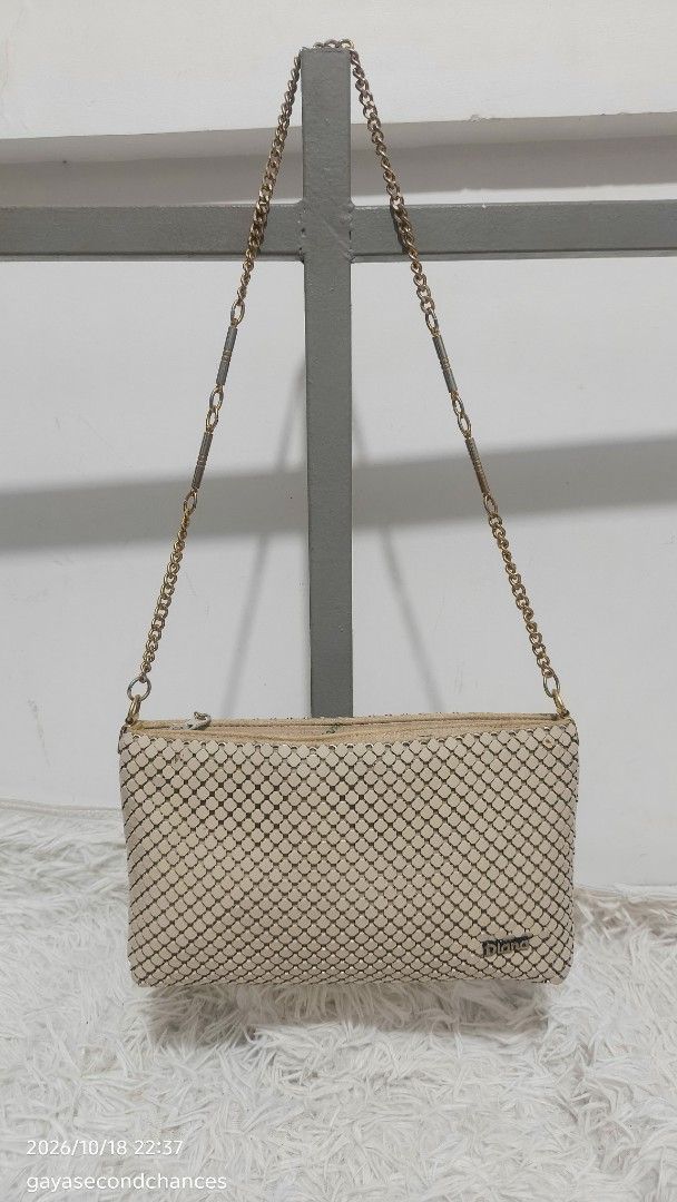 DIANA METAL MESH BAG (Category: Shoulder Bags) located in Kalibo. Submitted by secondchances.thriftsh8p (Listing ID 1468890715, Image 1). Description: - Brand: Diana - Color: Cream with gold-toned hardware - Material: Mesh body with textured metallic tile pattern - Strap: Gold-toned chain with segmented metal links - Closure: Top zipper with a 'symbol of quality' hanging metal tag - Interior: Fully fabric-lined - Size: Compact and easy to sling f