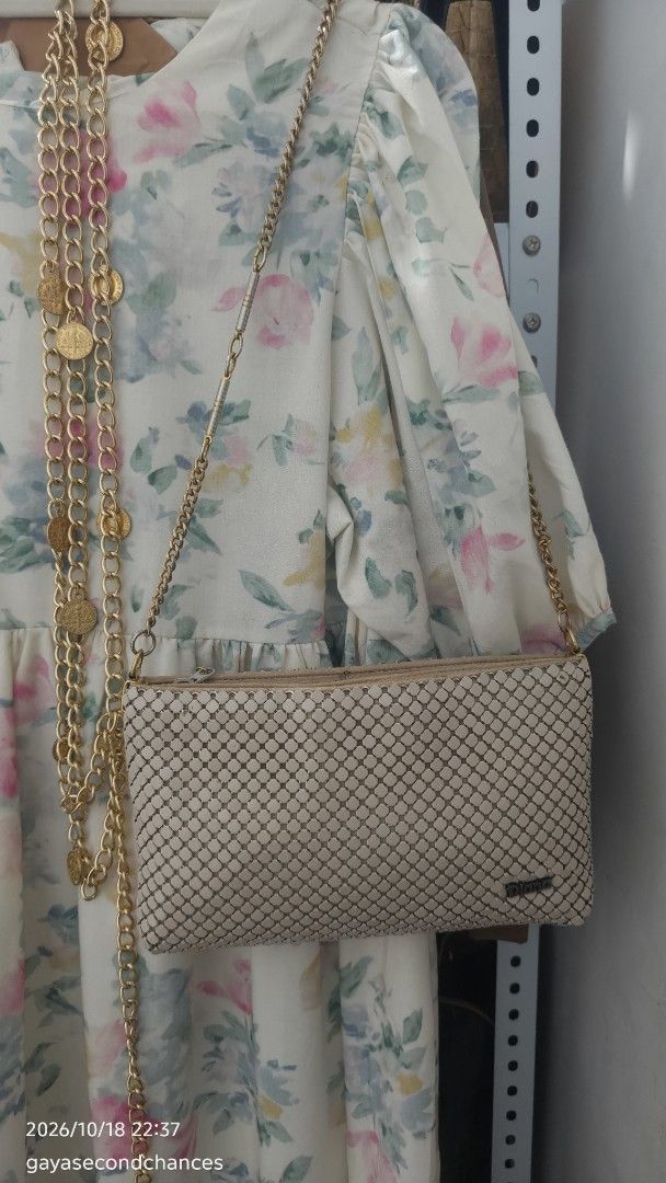 DIANA METAL MESH BAG (Category: Shoulder Bags) located in Kalibo. Submitted by secondchances.thriftsh8p (Listing ID 1468890715, Image 3). Description: - Brand: Diana - Color: Cream with gold-toned hardware - Material: Mesh body with textured metallic tile pattern - Strap: Gold-toned chain with segmented metal links - Closure: Top zipper with a 'symbol of quality' hanging metal tag - Interior: Fully fabric-lined - Size: Compact and easy to sling f