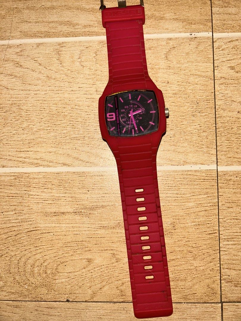 Diesel Trojan DZ1351 (Category: Women's Watches) located in Manila. Submitted by _zzaney (Listing ID 1468851999, Image 1). Description: - Brand/Model:Diesel “Trojan” Young Blood Red watch (Model: DZ1351) - Design: Bright red silicone strap and case with a bold black square dial - color: Bright pink sa personal - Accents: Eye-catching pink hour markers, hands, and large number 9 - Features: 24-hour inner track and stainless steel case back - Closu