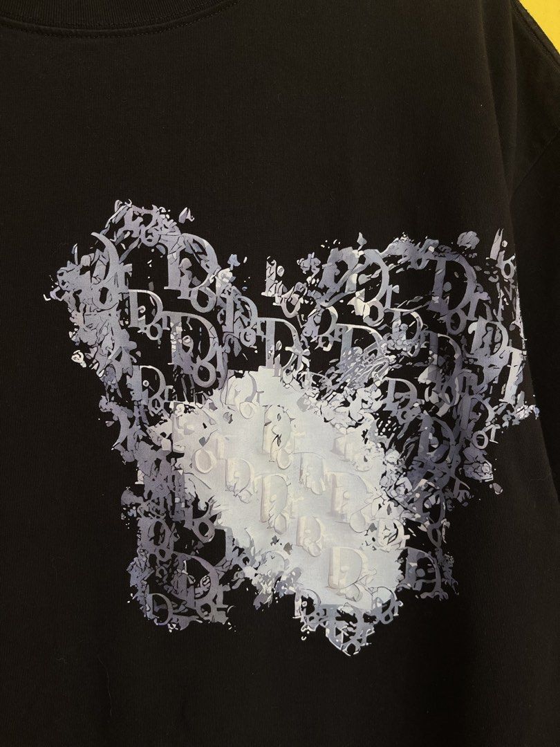 Dior Black Graphic T-Shirt (Category: Tshirts & Polo Shirts ) located in Baguio. Submitted by yuno.cartel (Listing ID 1468728425, Image 2). Description: - Brand: Dior - Color: Black with grey and white graphic print - Size: Medium (M) - Material: 100% viscose - Design: Unique graphic wrapping from front chest to back right hem - Fit: Crew neck with standard short sleeves -large fit boxy.