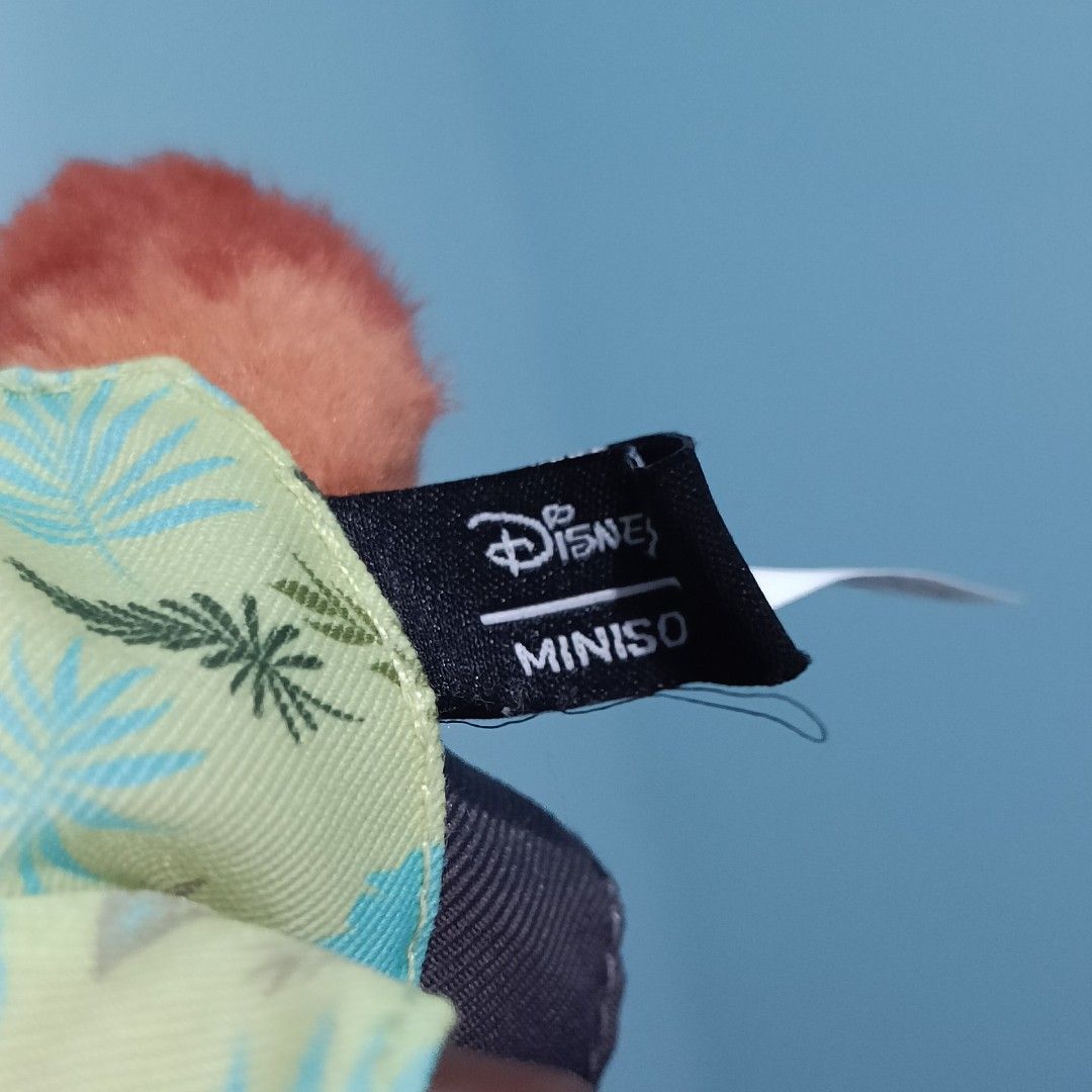Disney Miniso Zootopia Nick Wilde Plush Keychain (Category: Plushies & Soft Toys) located in Baguio. Submitted by baileybails (Listing ID 1468754667, Image 2). Description: - Authentic Disney Miniso Nick Wilde plush keychain - Wears a green tropical shirt, blue striped tie, and grey shorts - Features cute green eyes with star highlights - Includes original Miniso hanging strap and side fabric tags - Clean fabric with bright, vibrant colors - Perf