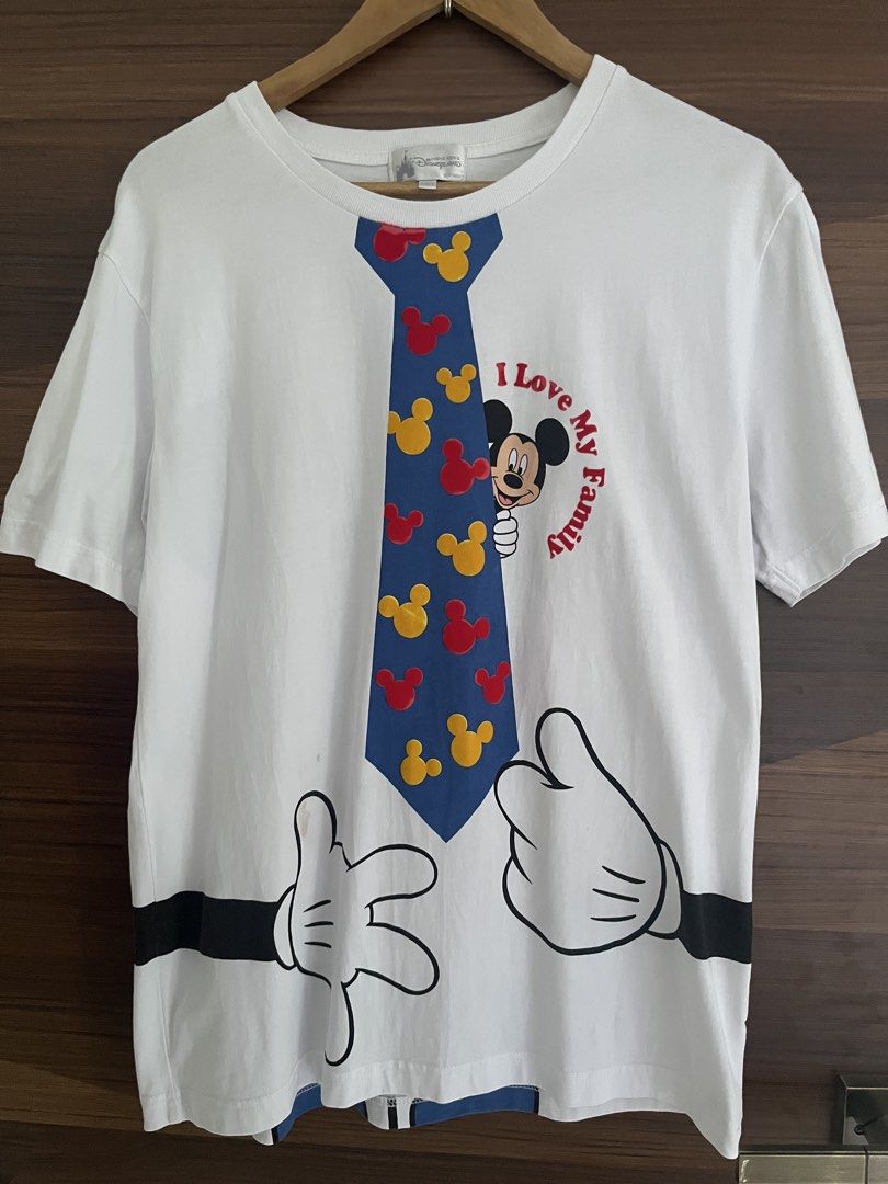 Disneyland Mickey Mouse Shirt (Category: Tshirts & Polo Shirts ) located in Manila. Submitted by thrifted.shits (Listing ID 1468766621, Image 1). Description: - Item: Hong Kong Disneyland Mickey Mouse Graphic Tee - Color: White - Size: L (Tag attached) - Design: Front features Mickey peeking behind a blue tie with red/yellow silhouettes; back features a large Mickey silhouette in striped shirt and blue shorts - Details: Short sleeves, crew neck -