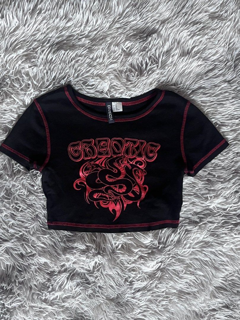 Divided H&M Black Red Snake Graphic Crop Top (Category: Shirts) located in Quezon City. Submitted by toasterpiee (Listing ID 1468882981, Image 1). Description: - Brand: Divided by H&M - Size: XS (Cropped fit) - Color: Black with red contrast stitching - Design: Chest graphic with 'chaotic' text and snakes - Material: Lightweight cotton blend - Details: Short sleeves and round neckline.
