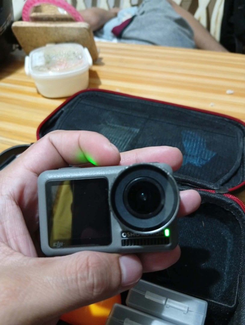 DJI Osmo Action Camera (Category: Cameras) located in Makati City. Submitted by yheenjiro123091 (Listing ID 1468797555, Image 2). Description: - Tested and 100% working DJI Osmo Action camera - Powers on successfully with green LED indicator active - Clear rear touchscreen displaying playback interface smoothly - Perfect compact device for travel, sports, and outdoor adventures - Includes protective carrying case and handy battery storage boxes -