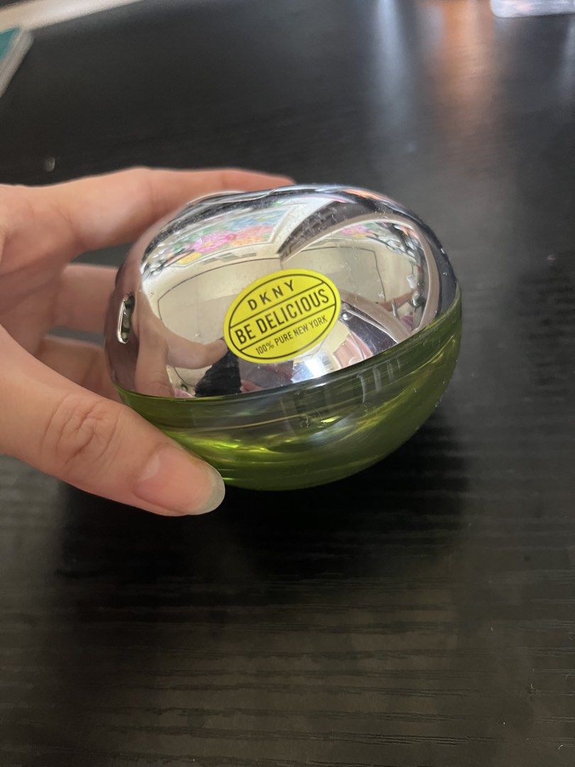 DKNY Be Delicious Eau de Parfum (Category: Fragrance & Deodorants) located in Rizal. Submitted by s0apandglory (Listing ID 1468769868, Image 3). Description: - Authentic DKNY Be Delicious perfume in iconic green apple bottle - Features silver metallic top cap with original yellow brand sticker intact - Green glass body clearly shows remaining fragrance level - Timeless, classic fresh scent perfect for daily wear - Well-maintained and ready for it