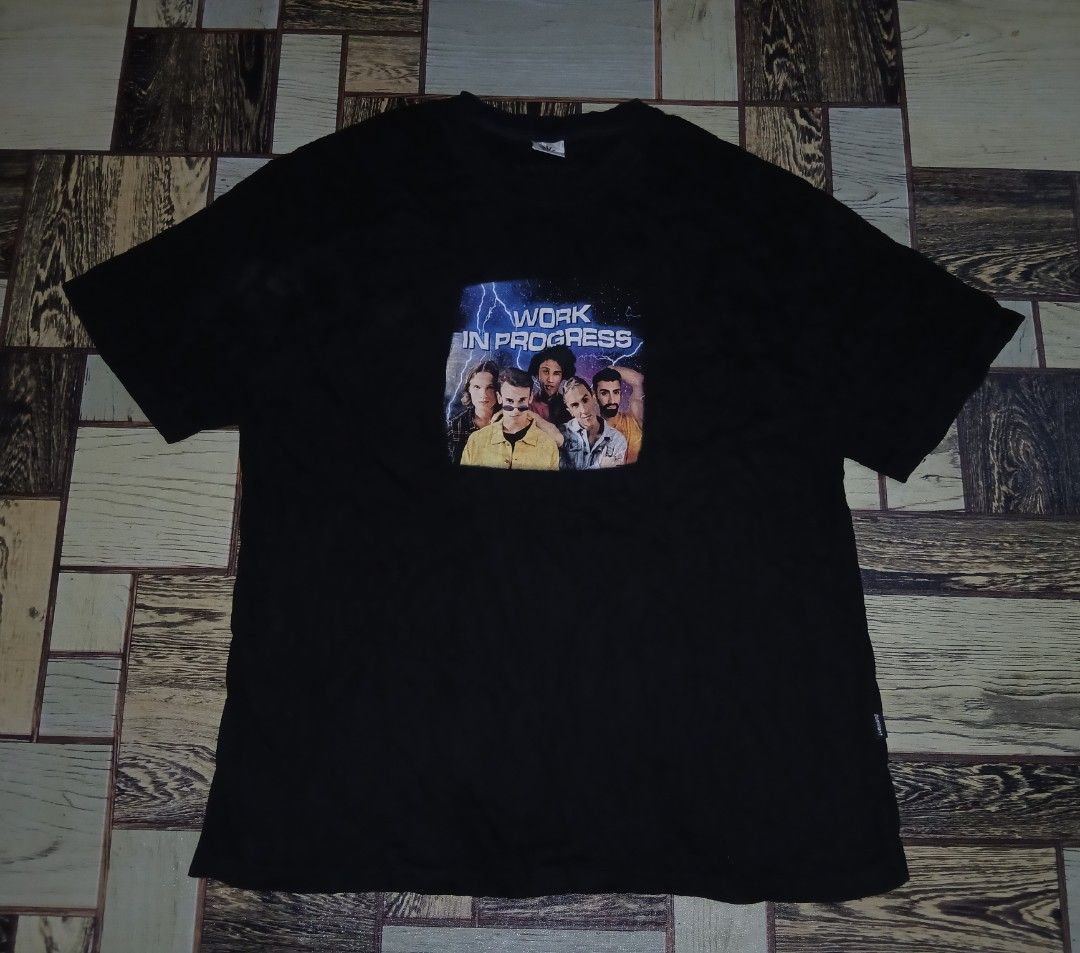 Dominant Work in Progress Graphic Black T-Shirt Size L (Category: Tshirts & Polo Shirts ) located in Caloocan City. Submitted by youngmoon_51e2c6 (Listing ID 1468792601, Image 1). Description: - Brand: Dominant - Color: Black - Size: Large - Pit to Pit: 23 inches - Material: Soft cotton - Origin: Made in Korea - Design: Front graphic print with 'Work in Progress' text, group photo, and lightning background - Condition: Excellent, graphic is clean