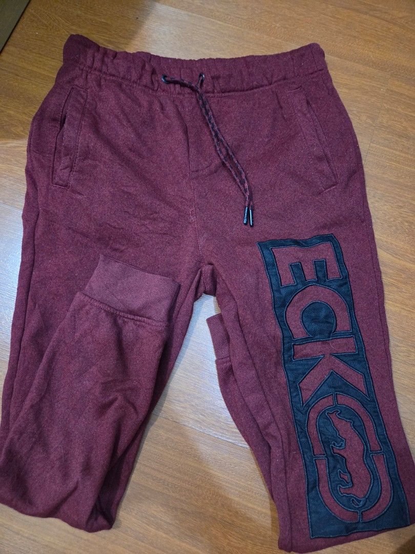 Ecko Unld. Maroon Sweatpants Size S (Category: Joggers) located in Taguig. Submitted by mon_143 (Listing ID 1468898583, Image 1). Description: - Brand: Ecko Unld - Color: Maroon - Size: Small fits up to large - Design: Large black graphic print on leg & back pocket patch - Features: Adjustable drawstring waist with branded metal tips & cuffed ankles - Material: Comfortable fabric, ideal for casual wear/loungewear.