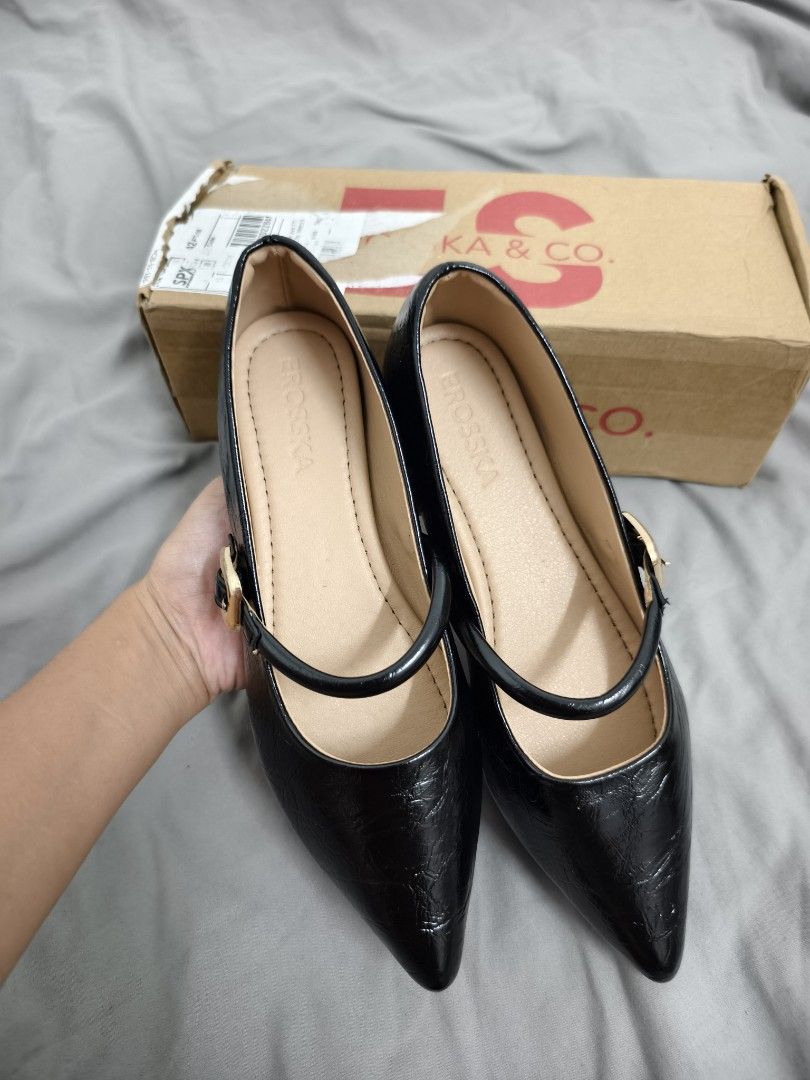Erosska & Co. Black Pointed Toe Flats (Category: Flats & Sandals) located in Angeles City. Submitted by measaliman02351 (Listing ID 1468749862, Image 3). Description: - Brand: Erosska & Co. - Style: Black pointed toe flats with slip-on design - Details: Strap across the top with a stylish gold buckle - Comfort: Nude inner lining and soft padded insoles for all-day wear - Inclusions: Comes with original branded box - Condition: Excellent / Ready t
