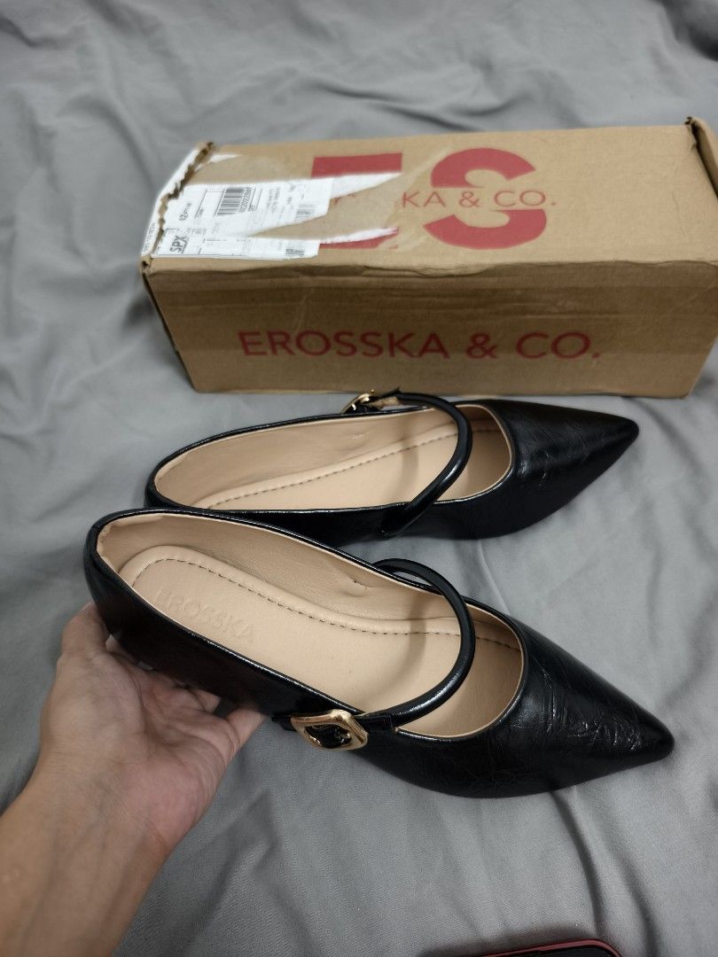 Erosska & Co. Black Pointed Toe Flats (Category: Flats & Sandals) located in Angeles City. Submitted by measaliman02351 (Listing ID 1468749862, Image 1). Description: - Brand: Erosska & Co. - Style: Black pointed toe flats with slip-on design - Details: Strap across the top with a stylish gold buckle - Comfort: Nude inner lining and soft padded insoles for all-day wear - Inclusions: Comes with original branded box - Condition: Excellent / Ready t
