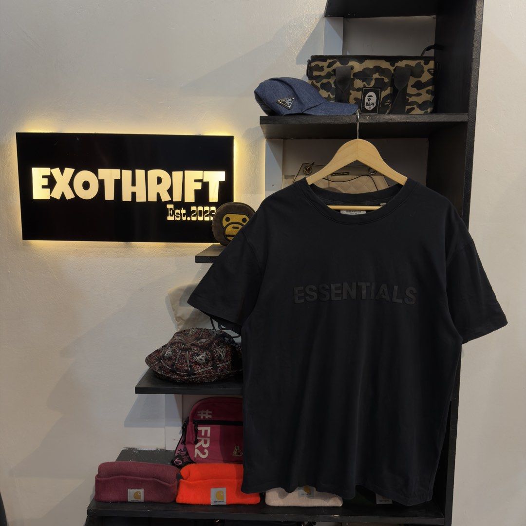 Essentials Black Mid Script Shirt (Category: Tshirts & Polo Shirts ) located in Manila. Submitted by jerichomal82553 (Listing ID 1468899080, Image 1). Description: Essentials Black Mid Script Shirt 22 by 29.5 Good Condition Complete Tags CLAIM 1300.