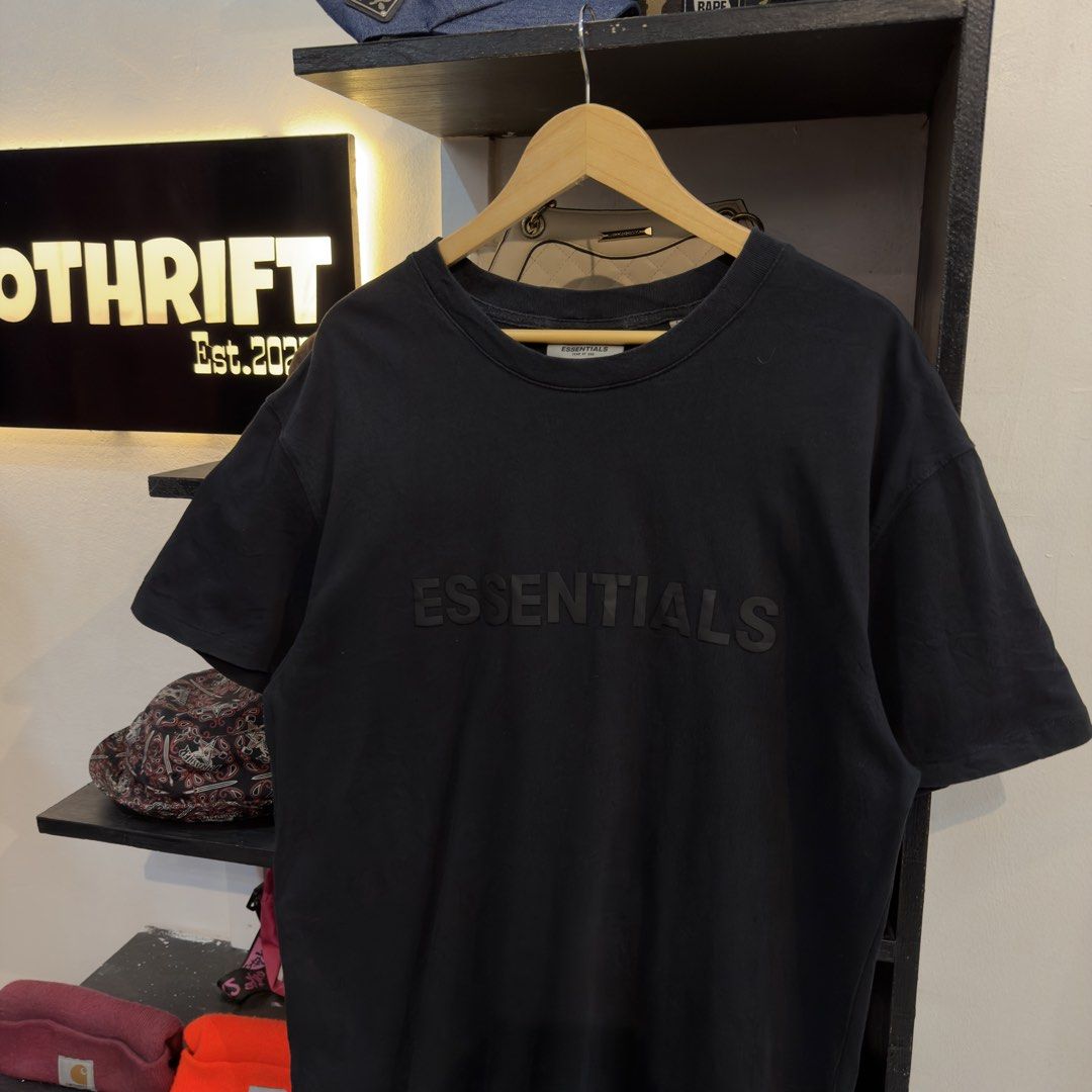 Essentials Black Mid Script Shirt (Category: Tshirts & Polo Shirts ) located in Manila. Submitted by jerichomal82553 (Listing ID 1468899080, Image 2). Description: Essentials Black Mid Script Shirt 22 by 29.5 Good Condition Complete Tags CLAIM 1300.