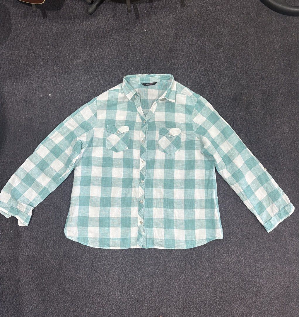 Essenxa Green White Plaid Button Up Shirt XL (Category: Shirts) located in Quezon City. Submitted by fast.closetfinds (Listing ID 1468774792, Image 1). Description: - Brand: Essenxa - Size: XL - Color/Pattern: Green and white check - Design: Long sleeves with metallic snap-button closure - Pockets: Dual chest pockets with button flaps - Fabric: Lightweight and comfortable for casual wear.