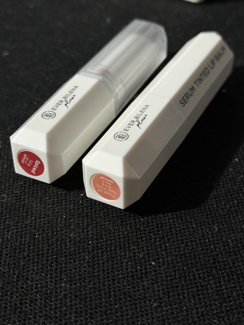 Ever Bilena Plus Serum Tinted Lip Balm Set (Category: Makeup) located in Malabon City. Submitted by annshopable_ (Listing ID 1468858870, Image 1). Description: - Brand: Ever Bilena Plus - Product: Serum Tinted Lip Balm Bundle - Shades: Spiced & Toast of New York - Size: 3.2g per stick - Condition: Barely used, twist-up mechanism works smoothly - Packaging: White hexagonal tubes with clear caps - Ideal for: Everyday wear and effortless looks Take 