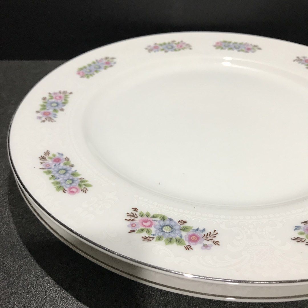 Everbrite Rosanne Fine China Dinner Plates Set (Category: Dinnerware & Cutlery) located in Baao. Submitted by all.things.japan (Listing ID 1468744774, Image 3). Description: 10.25 x 0.75 inches -Brand/Origin: Everbrite Rosanne, Made in Japan - Material: Fine white porcelain - Design: Pink and blue floral clusters with embossed details and silver trim - Condition: Excellent, clean bottoms with original maker stamps intact - Perfect for: Dining col