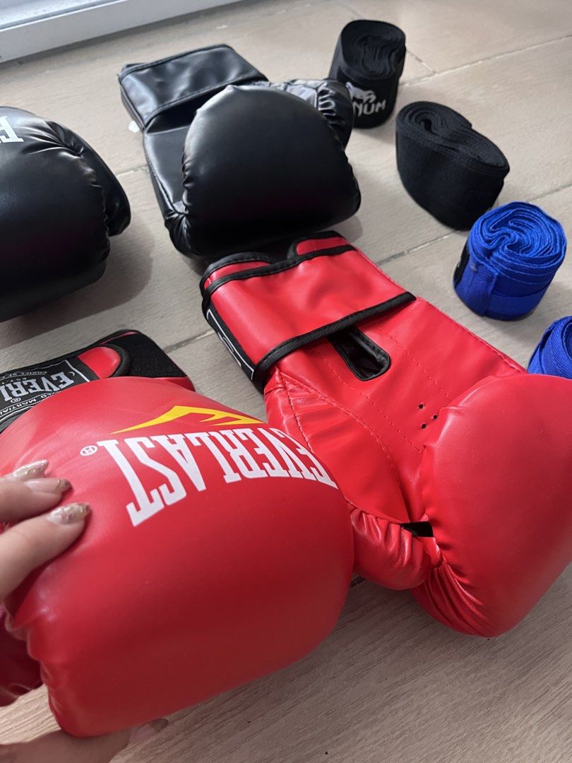 2 Pairs Boxing Gloves and Hand Wraps Bundle (Category: Combat Sports) located in Taguig. Submitted by graceeeee. (Listing ID 1468733331, Image 2). Description: - 2-person boxing/kickboxing starter kit - No issues. Used once. Cleaned. - 10oz gloves (1 black pair) and 12oz gloves (1 red pair) - Hand wraps included (2 black pairs, 2 blue pairs) - Bought from Laz 900+ Php RFS: moving out Loc: next to Venice Mall, Taguig.