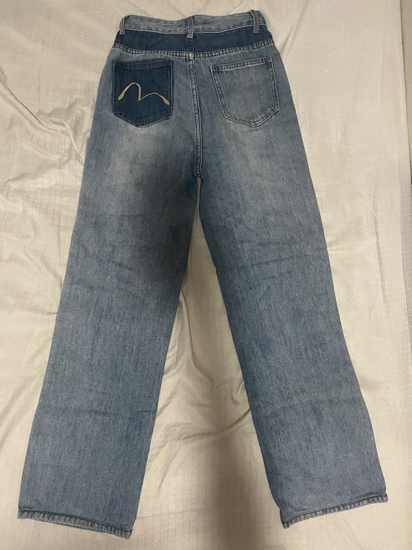 Evisu Light wash blue denim jeans (Category: Jeans) located in Manila. Submitted by chococoffeeboy (Listing ID 1468864559, Image 3). Description: Evisu light blue jeans Style: Casual streetwear, easy to match with tees and hoodies - Zip fly and metal button closure - Design: Light wash denim with contrasting dark waistband and back pocket panels -No back patch - Details: Gold embroidered Evisu logo on coin and back pockets Waist: 24” Length: 39.5