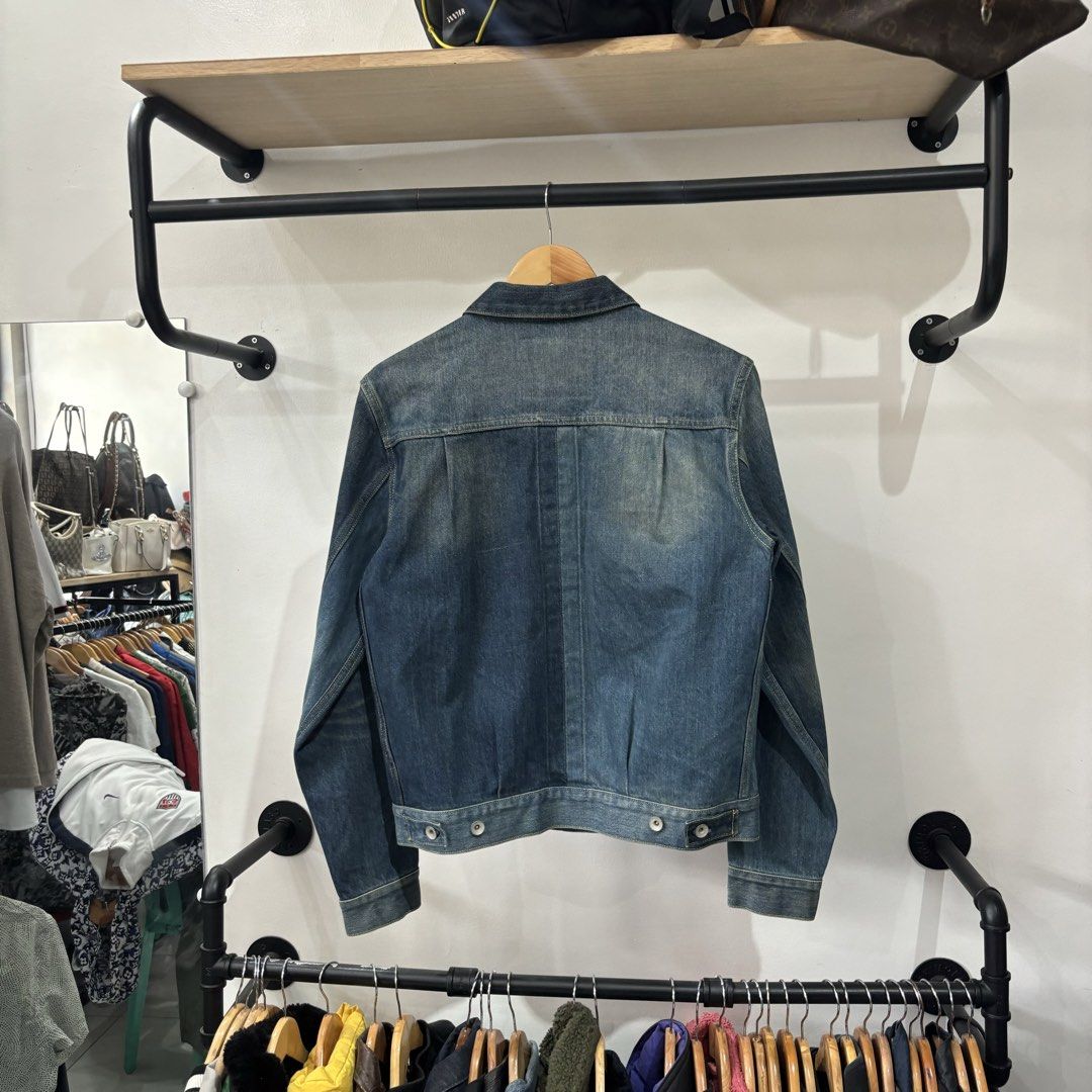 Evisu Selvedege Denim Jacket Blue Size L (Category: Coats, Jackets and Outerwear) located in Bambang. Submitted by heats777 (Listing ID 1468827920, Image 3). Description: - Brand: Evisu - Size: L (indicated on interior leather patch) - Color/Wash: Blue with contrast color block front panels - Pockets: Two chest pockets (one with signature embroidered gull detail) - Hardware: Metal buttons with engraved branding - Design Features: Pleated back det