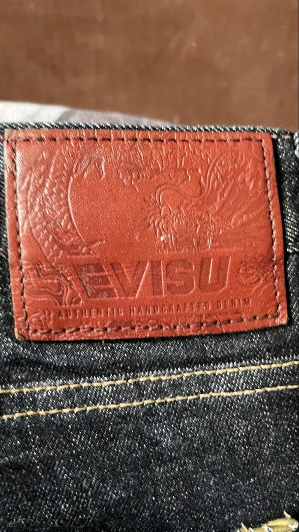 Evisu Slim Fit Camo Pocket Jeans (Category: Jeans) located in Tacloban City. Submitted by rxluminoque (Listing ID 1468832759, Image 3). Description: Size 34x40 - Brand: Evisu - Fit: Slim fit - Color: Clean dark indigo wash - Details: Camouflage back pockets with classic gull embroidery - Hardware: Branded metal buttons and leather back patch - Interior: Stamped typography graphics on pocket lining - Condition: Excellent .