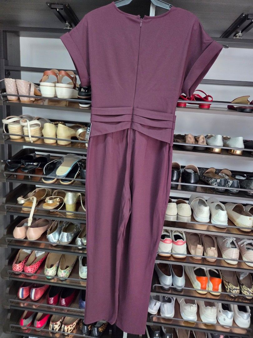 Express Burgundy Jumpsuit Size S (Category: Jumpsuits) located in San Juan City. Submitted by wisedolphin_5a645c (Listing ID 1468718540, Image 3). Description: - Brand: Express - Color: Rich burgundy - Size: S - Condition: Brand new with original tag attached - Material/Origin: Made in Sri Lanka - Design details: Short cuffed sleeves, V-neckline, back zipper closure, and pleated waist detailing - Style: Clean lines, classic color, and easy one-pi