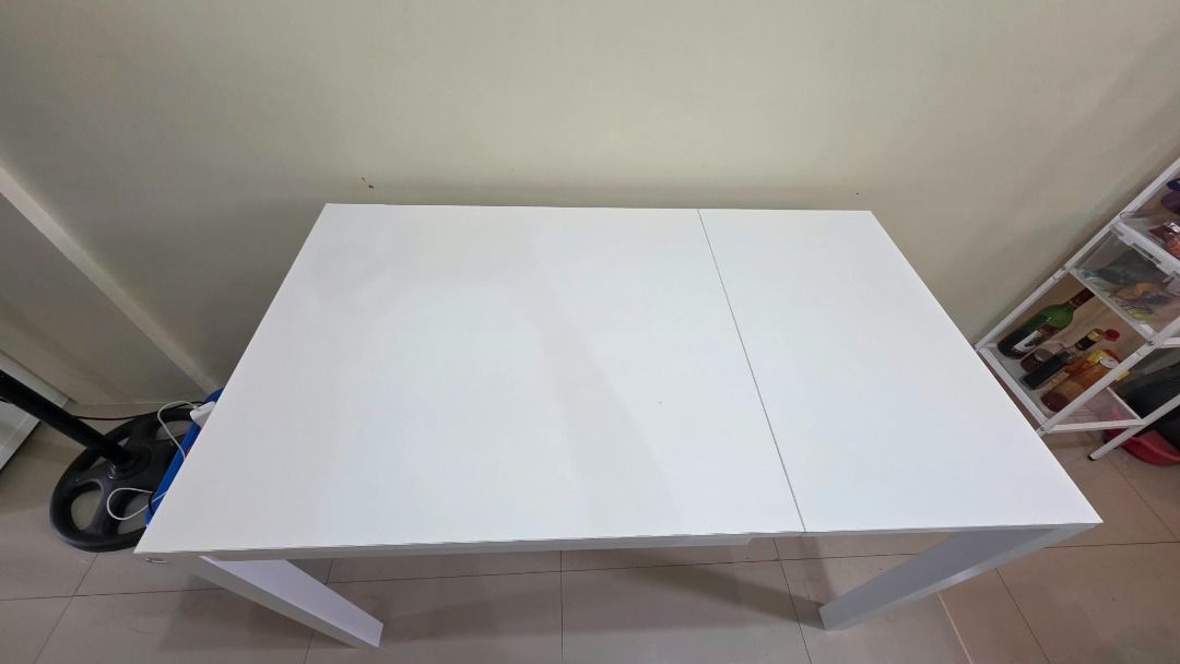 Extendable white dining table (Category: Tables & Sets) located in Makati City. Submitted by maria.valderama (Listing ID 1468881738, Image 3). Description: - White extendable dining table with smooth surface - Sturdy metal frame for daily durability - Ideal for small spaces, apartments, or cozy dining areas - Easy-to-use pull-out leaf panel for extra seating capacity ✨ CONDITION - please see photos to appreciate 📍 LOCATION: EDSA Shaw / Queensrow