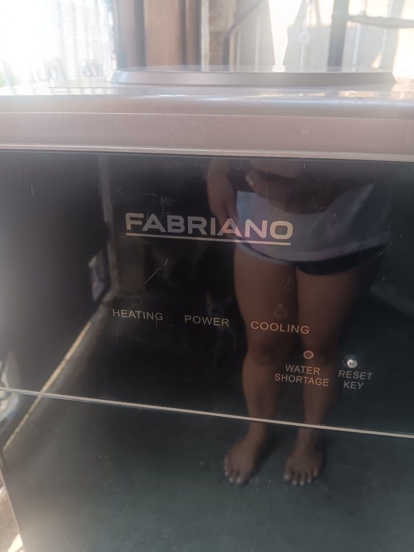 Fabriano Standing Water Dispenser (Category: Water Purifiers & Dispensers) located in Las Pinas. Submitted by jesus1smysavi0r (Listing ID 1468731401, Image 2). Description: NEEDS REPAIR. WATER NOT FLOWING Fabriano floor standing water dispenser unit. Features hot, cold, and ambient temperature tap buttons. Black and bronze finish. Control panel on top with indicators for heating, power, cooling, and water shortage reset key. Standard power plug a