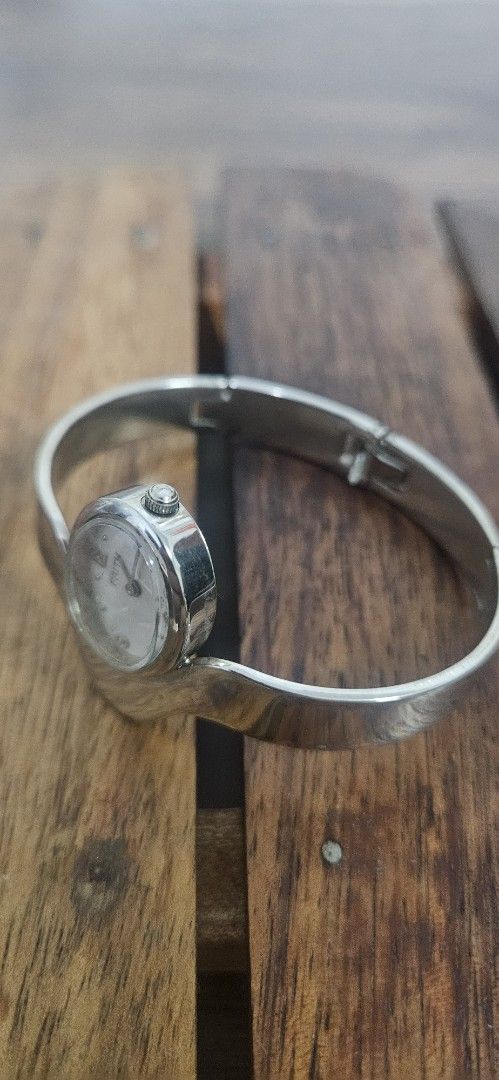 FAITH Quartz Bangle Watch Silver Tone (Category: Women's Watches) located in Santa Maria. Submitted by rommelmateo (Listing ID 1468861004, Image 2). Description: - Brand: FAITH - Movement: Quartz with Japan parts - Design: Shiny silver finish with oval white face and clear number markers (3, 6, 9, 12) - Band: Solid bangle style with secure hinge clasp closure - Style: Clean, polished, and elegant.