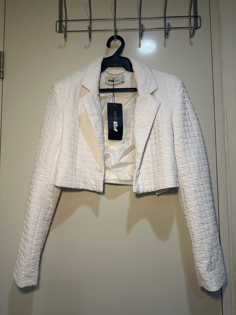 FB Sister White Textured Crop Blazer (Category: Coats, Jackets and Outerwear) located in Taguig. Submitted by ellajanee (Listing ID 1468767672, Image 1). Description: - Brand: FB Sister - Item: Cropped White Blazer - Size: S (fits true to size) - Condition: Brand new with tags (BNWT), never worn - Details: Textured fabric, open front design, lapel collar, fully lined - Style: Great for smart casual outfits and layering.