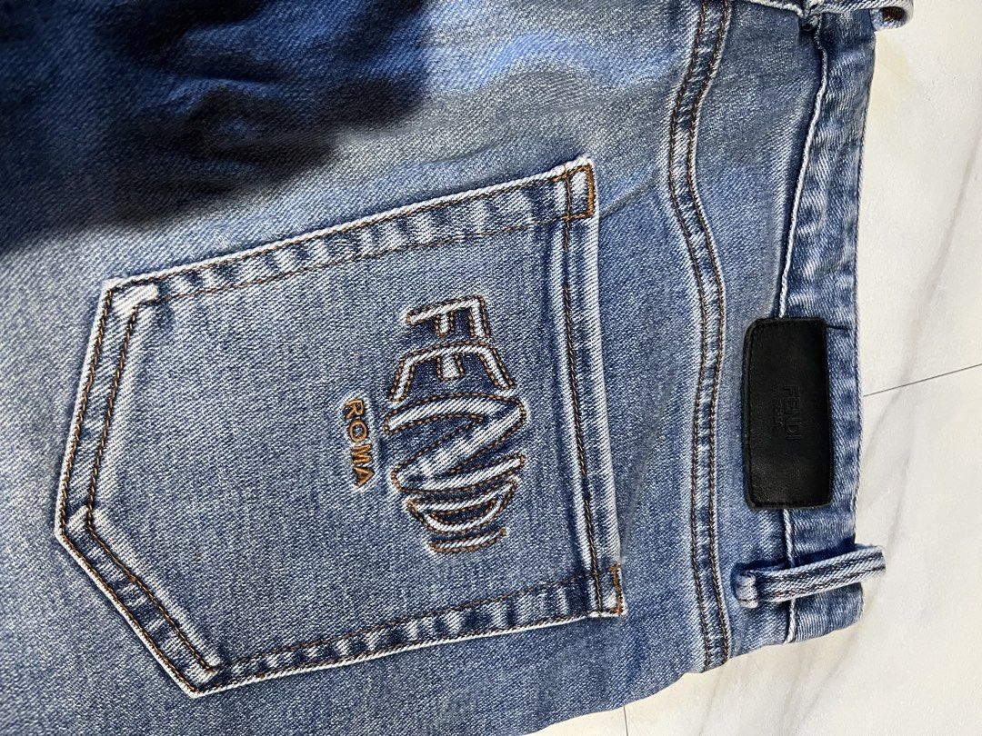 Fendi Roma Blue Denim Jeans (Category: Jeans) located in Cavite. Submitted by christianzuuu (Listing ID 1468766142, Image 2). Description: Fendi denim jeans in mid blue wash. Embroidered Fendi Roma logo on the back pocket. Branded hardware on buttons and leather patch on waistband. Straight leg fit with classic five-pocket styling. Tagged waist 33 and length 34. Measured laying flat: waist 17 inches, length 41 inches, leg opening 9.5 inches..