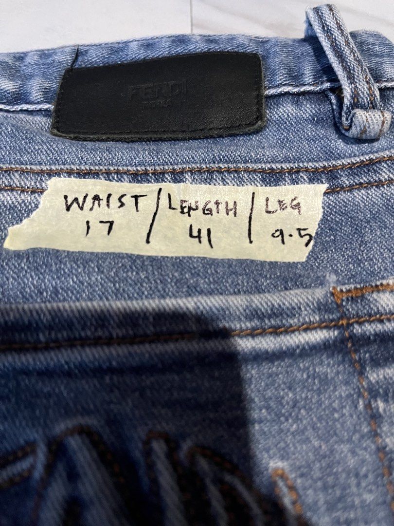 Fendi Roma Blue Denim Jeans (Category: Jeans) located in Cavite. Submitted by christianzuuu (Listing ID 1468766142, Image 3). Description: Fendi denim jeans in mid blue wash. Embroidered Fendi Roma logo on the back pocket. Branded hardware on buttons and leather patch on waistband. Straight leg fit with classic five-pocket styling. Tagged waist 33 and length 34. Measured laying flat: waist 17 inches, length 41 inches, leg opening 9.5 inches..