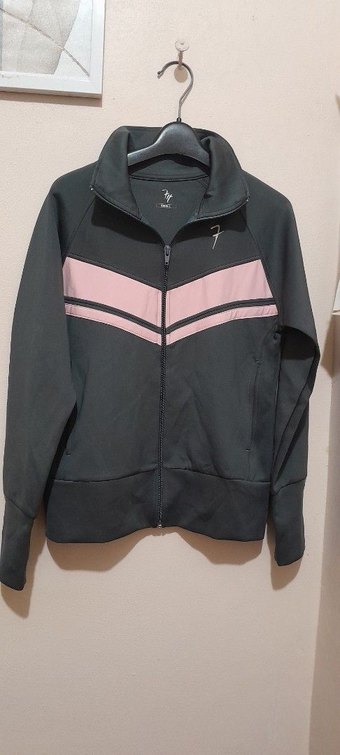 Fit Track Active Jacket Grey with Pink Stripes (Category: Coats, Jackets and Outerwear) located in Quezon City. Submitted by anlimorevoni (Listing ID 1468803428, Image 1). Description: - Brand/Model: Fit Track active jacket - Color: Dark grey with striking pink chevron stripes - Closure: Full zip front with high collar for wind protection - Sleeves: Long sleeves featuring convenient thumbholes at cuffs - Pockets: Two secure zipped side pockets - 