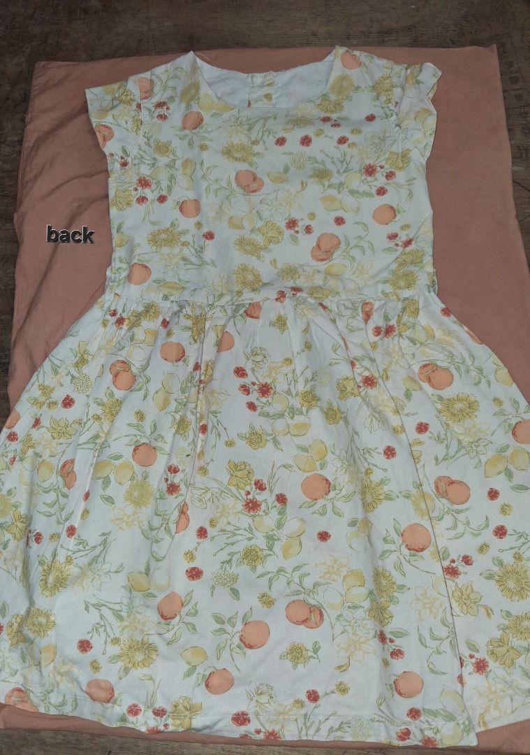 Floral Dress (Category: Babies & Kids Fashion) located in Caloocan City. Submitted by pauline.preloved.stuff (Listing ID 1468752071, Image 2). Description: Super cute white cotton dress featuring a vibrant fruit and floral print. Perfect for warm weather with a fitted bodice, flared pleated skirt, and back button closure. Fits size 5/7..