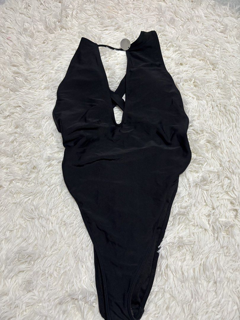 Forever 21 Black One Piece Swimsuit (Category: Bikinis & Swimsuits) located in Quezon City. Submitted by lovedbysloane (Listing ID 1468721090, Image 1). Description: - Brand: Forever 21 - Item: One-piece swimsuit - Color: Black - Size: L - Design: Plunging neckline with criss-cross back straps - Material: Nylon/Polyamide & Spandex/Elastane - Condition: Brand new with original tags attached, never worn - Environment: Clean, smoke-free home.
