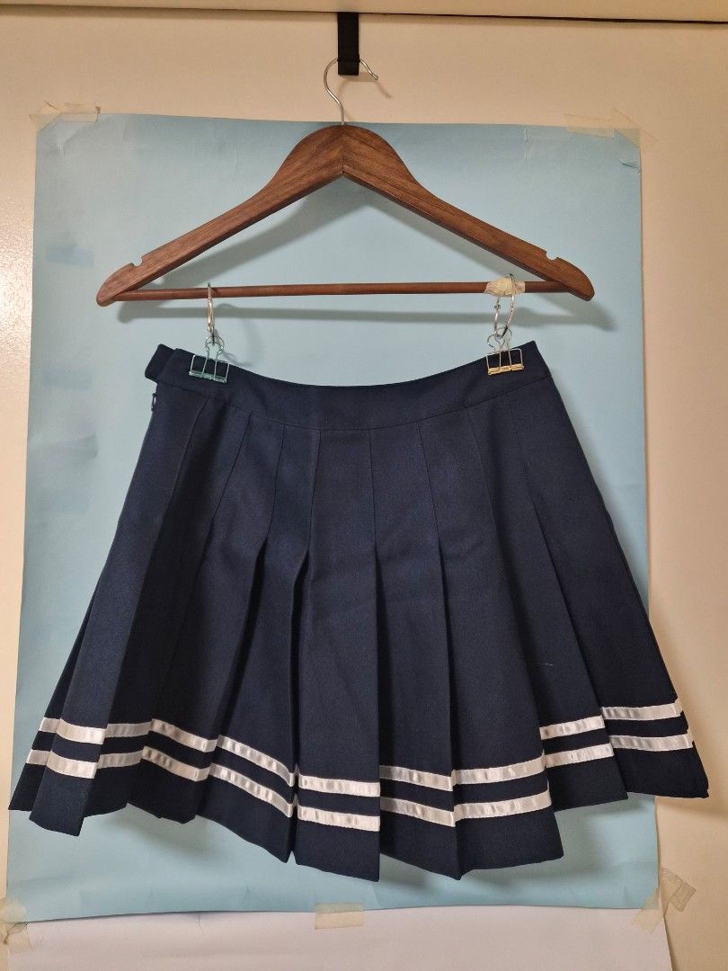 Forever 21 Navy Pleated Skirt Size M (Category: Skirts) located in Manila. Submitted by prelovedbyc.hannah (Listing ID 1468779759, Image 2). Description: - Brand: Forever 21 - Size: M (165/72A) - Color: Navy blue with white double stripe accents - Closure: Side zipper and matching waistband button - Details: Textured fabric with a clean interior lining.