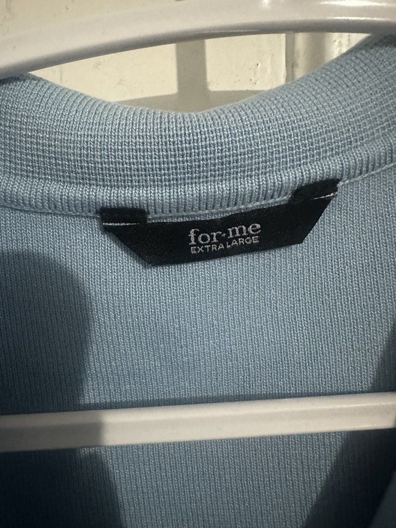 for·me Blue Knit Polo Shirt Extra Large (Category: Longsleeves) located in Naga. Submitted by leelovella64554 (Listing ID 1468778273, Image 2). Description: - Brand: for·me - Size: Extra Large (XL) - Color: Light blue with white trim along the collar - Style: V-neck knit polo shirt with short sleeves and ribbed hem - Fit: Relaxed fit, comfortable material.