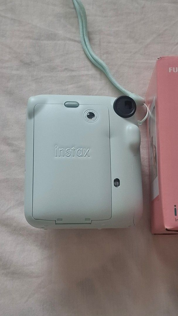 Fujifilm Instax Mini 12 Instant Camera Mint Green (Category: Cameras) located in Makati City. Submitted by isell_goods (Listing ID 1468715328, Image 3). Description: - Fujifilm Instax Mini 12 instant camera in Mint Green - Includes original pink box and matching hand strap - Simple twist-to-turn lens for standard and close-up modes - Built-in automatic exposure and flash for hassle-free shooting - Uses standard Instax Mini film.
