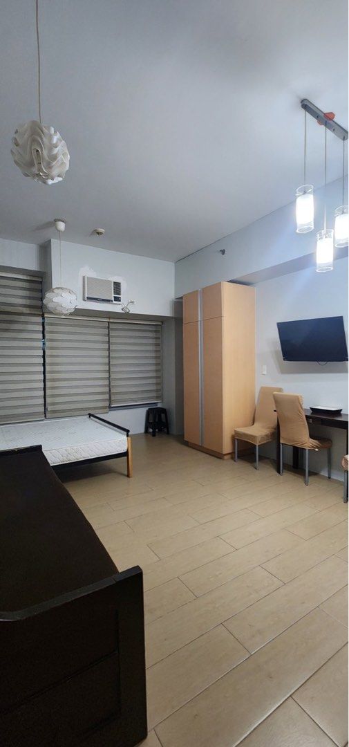 Fully Furnished Studio (Category: Apartments & Condos) located in Makati City. Submitted by theacd (Listing ID 1468792972, Image 1). Description: - Move-in ready studio unit with a great, spacious layout - Fully furnished with a comfortable bed, sofa bed, wardrobe, and dining set - Equipped kitchen featuring built-in cabinets, electric stove, range hood, refrigerator, and microwave - Modern bathroom with a separate glass shower enclosure and wate