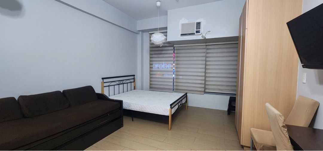 Fully Furnished Studio (Category: Apartments & Condos) located in Makati City. Submitted by theacd (Listing ID 1468792972, Image 2). Description: - Move-in ready studio unit with a great, spacious layout - Fully furnished with a comfortable bed, sofa bed, wardrobe, and dining set - Equipped kitchen featuring built-in cabinets, electric stove, range hood, refrigerator, and microwave - Modern bathroom with a separate glass shower enclosure and wate