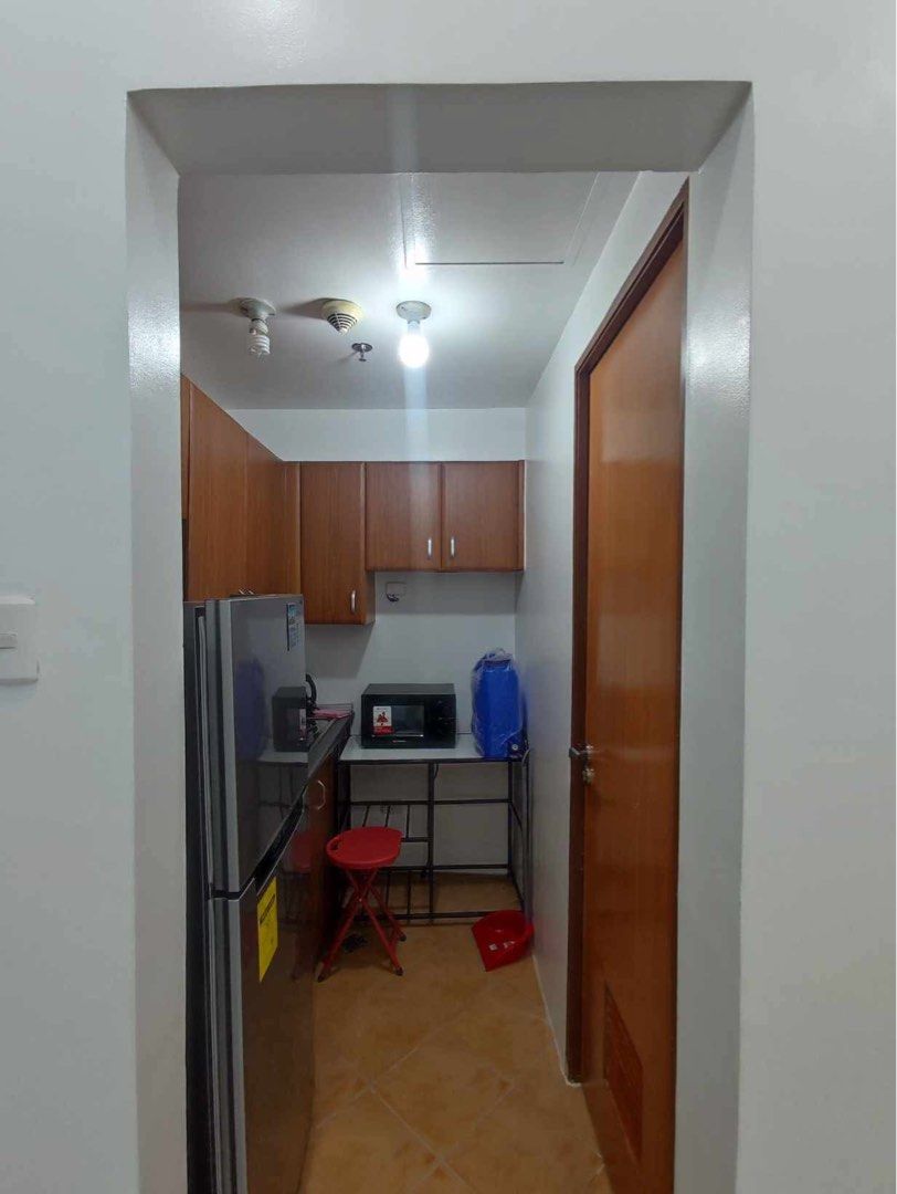Fully Furnished Studio Unit for Rent (Category: Apartments & Condos) located in Makati City. Submitted by theacd (Listing ID 1468793558, Image 2). Description: - Studio unit ready for immediate occupancy - Sleeping area with bunk bed setup (upper and lower) - Study table with 4 chairs included - Brown storage cabinet for your belongings - Kitchen section with refrigerator, microwave, and upper wooden cabinets - Clean white walls and elegant marbl