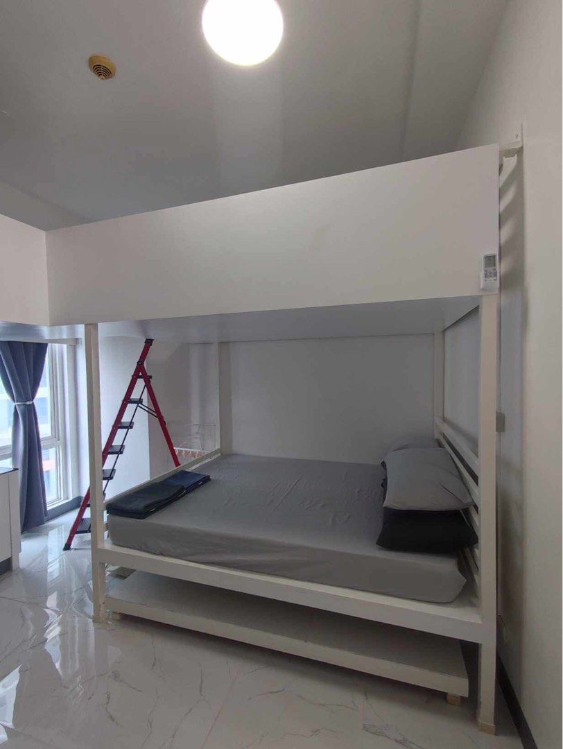 Fully Furnished Studio Unit for Rent (Category: Apartments & Condos) located in Makati City. Submitted by theacd (Listing ID 1468793558, Image 3). Description: - Studio unit ready for immediate occupancy - Sleeping area with bunk bed setup (upper and lower) - Study table with 4 chairs included - Brown storage cabinet for your belongings - Kitchen section with refrigerator, microwave, and upper wooden cabinets - Clean white walls and elegant marbl