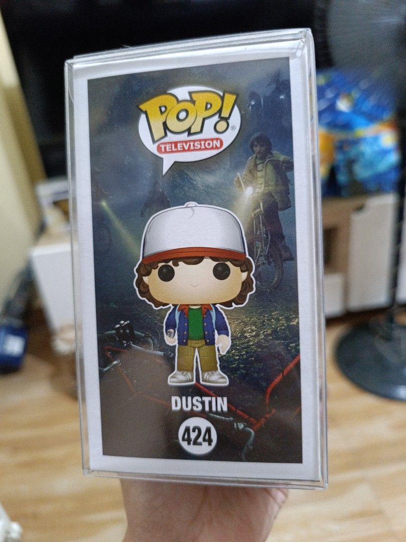Funko Pop Stranger Things Dustin #424 (Category: Designer & Blind Box Toys) located in Makati City. Submitted by urbanhoarder (Listing ID 1468745984, Image 3). Description: Character: Dustin (Stranger Things) - Item: Funko Pop! Television #424 - Outfit: Classic look with trucker hat, blue jacket, and green shirt - Protection: Includes a clear plastic protector case - Authenticity: Official Netflix merchandise - Condition: Great addition to any Ha