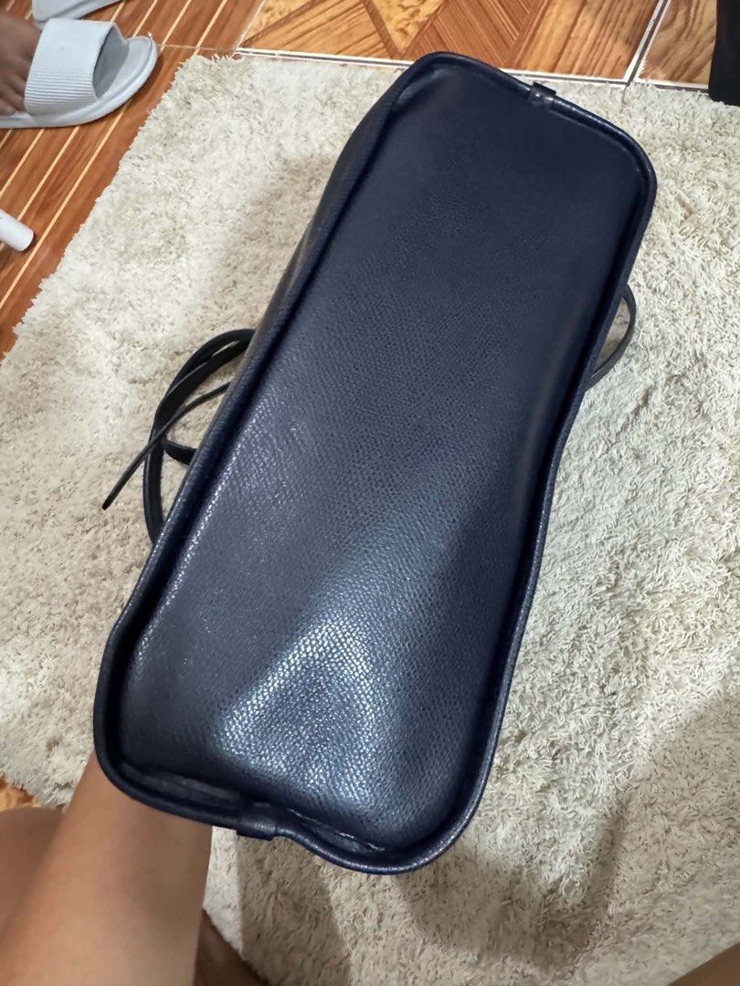 Furla Black Shoulder Bag with Chain Strap (Category: Luxury Bags & Wallets) located in Lipa City. Submitted by thyra06 (Listing ID 1468838515, Image 2). Description: - Color & Material: Premium black leather with sleek gold hardware - Handles: Unique ruched top handle and an adjustable chain strap - Closure: Secure lock closure on the front flap - Interior: Fabric-lined with a zip pocket and slip pockets for easy organization - Base: Clean textur