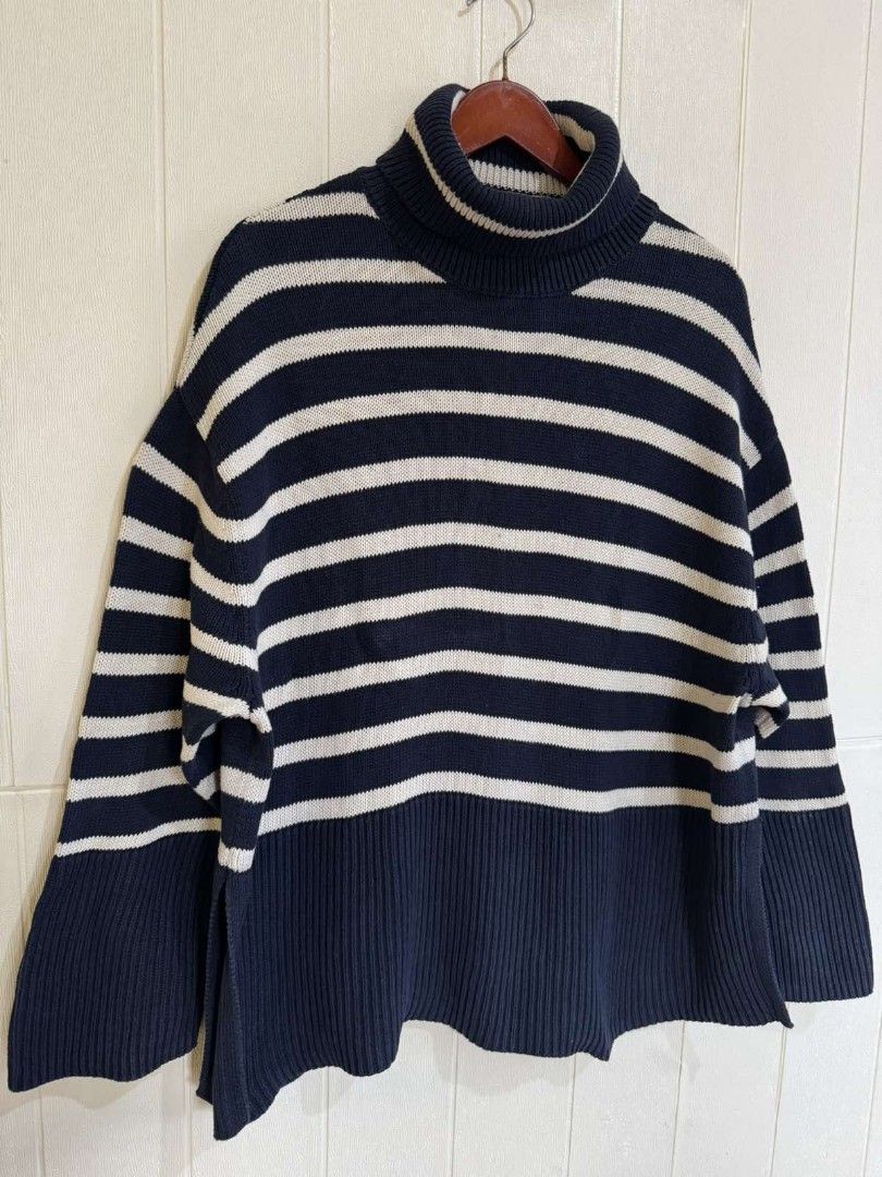 GAP Navy Striped Turtleneck Sweater Size M (Category: Longsleeves) located in Calamba. Submitted by iam.hides (Listing ID 1468724470, Image 3). Description: - Brand: GAP - Size: M (Made in Bangladesh) - Color: Navy blue and white stripes - Material: Cozy knit fabric - Features: Chunky ribbed turtleneck collar and hem - Condition: Great layering piece for cooler weather.