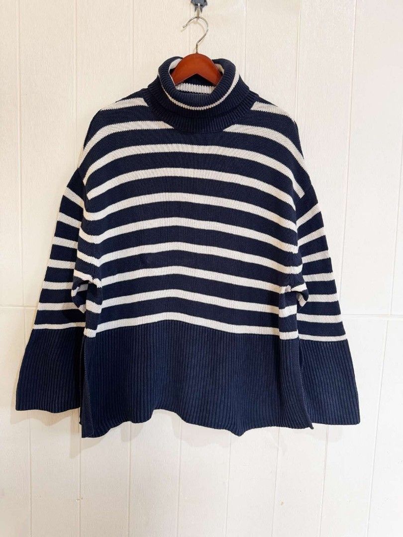 GAP Navy Striped Turtleneck Sweater Size M (Category: Longsleeves) located in Calamba. Submitted by iam.hides (Listing ID 1468724470, Image 2). Description: - Brand: GAP - Size: M (Made in Bangladesh) - Color: Navy blue and white stripes - Material: Cozy knit fabric - Features: Chunky ribbed turtleneck collar and hem - Condition: Great layering piece for cooler weather.