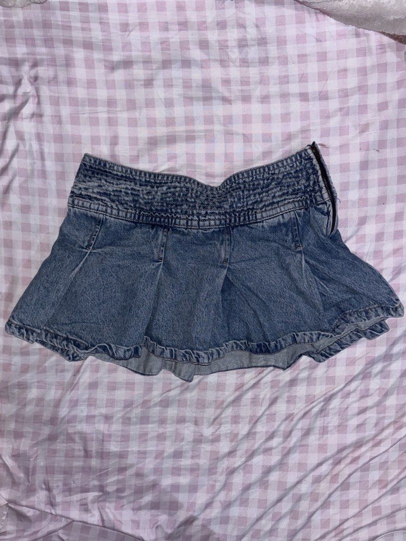 Garage Pleated Denim Skort (Category: Skirts) located in Baguio. Submitted by farrahlouh (Listing ID 1468854365, Image 1). Description: This signature Y2K-inspired style features a distinctive wide smocked/elasticized waistband, multi-directional box pleats that flare into a ruffled visual effect, an exposed side zipper closure, and hidden built-in shorts underneath for comfort..