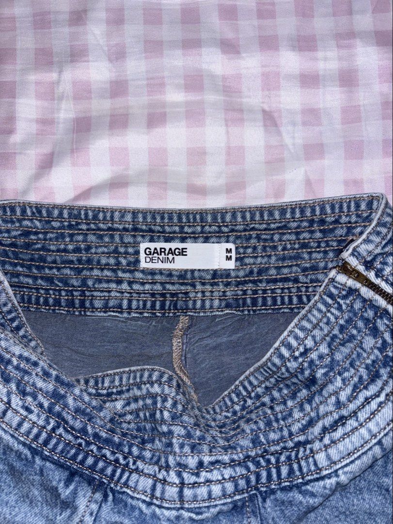 Garage Pleated Denim Skort (Category: Skirts) located in Baguio. Submitted by farrahlouh (Listing ID 1468854365, Image 3). Description: This signature Y2K-inspired style features a distinctive wide smocked/elasticized waistband, multi-directional box pleats that flare into a ruffled visual effect, an exposed side zipper closure, and hidden built-in shorts underneath for comfort..