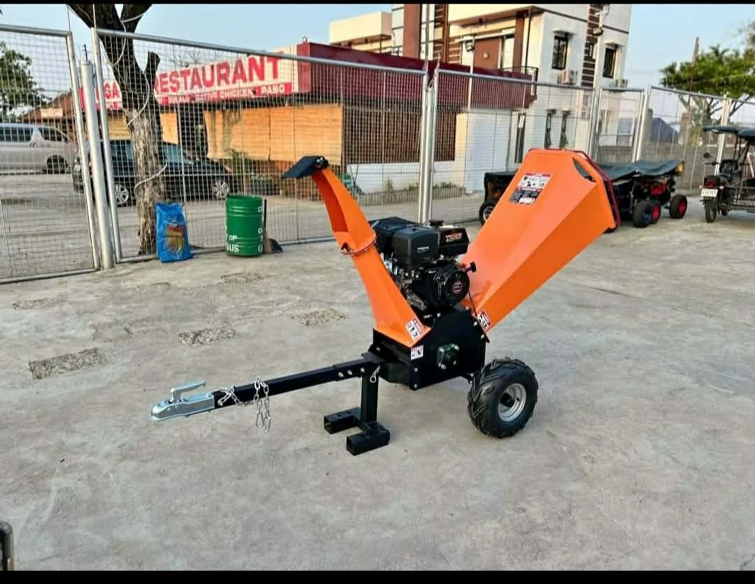 Gas Powered Wood Chipper Shredder (Category: Industrial Equipment) located in Manila. Submitted by puretiger.2cd3d1 (Listing ID 1468826601, Image 1). Description: - Type: Gas-powered wood chipper - Color: Orange and black - Engine: Reliable small engine mounted in the middle - Mobility: Equipped with wheels and a tow bar hitch for easy transport - Design: Heavy-duty construction featuring a large hopper and discharge chute - Condition: Great work