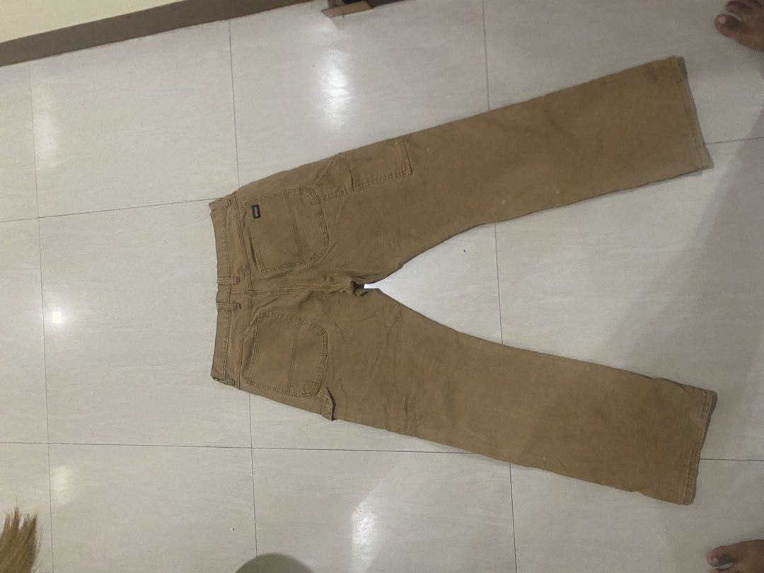 Genuine Dickies Brown Carpenter Pants Size 36x32 (Category: Jeans) located in Vinzons. Submitted by gabrielvic (Listing ID 1468740198, Image 3). Description: - Brand: Genuine Dickies - Style: Classic carpenter utility pants with hammer loop and tool pockets - Size: 36 x 32 - Material: Heavy-duty cotton canvas (Made in Kenya) - Closure: Button waist with zip fly - Condition: Shows natural wear, fading, and some spots throughout from use.